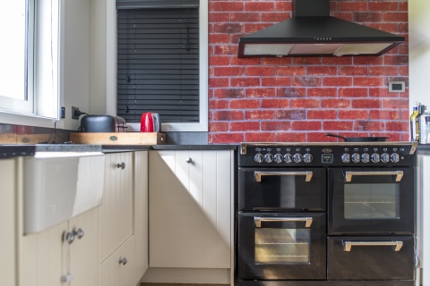 Black appliances and fittings add a bold statement to this home...